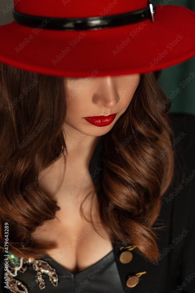 Fototapeta premium Pretty fashionable woman with red lips and hat with curly hairstyle in stylish clothes