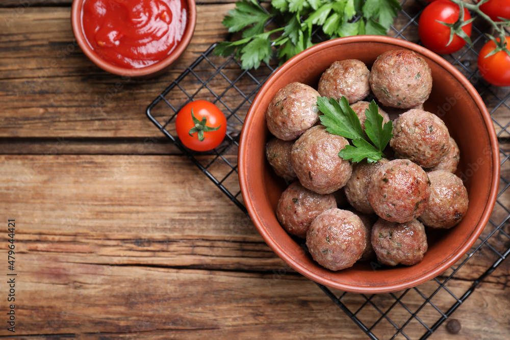 Tasty cooked meatballs with parsley on wooden table, flat lay. Space for text Tasty cooked meatballs with parsley on wooden table, flat lay. Space for text