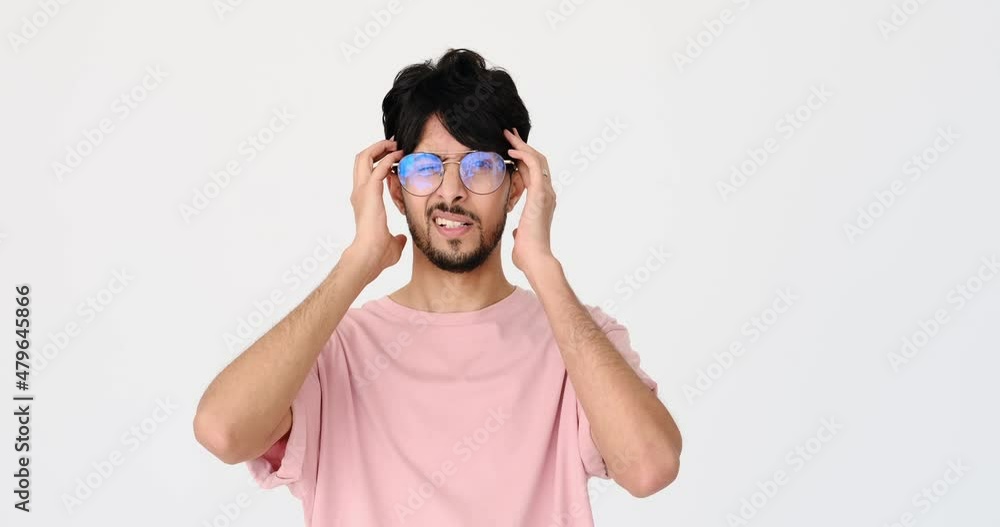 Young man suffering from severe headache over white background Young man suffering from severe headache over white background