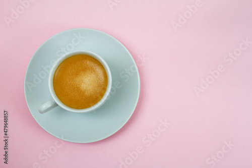 a cup of coffee on pink background