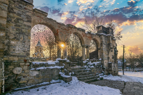 The ornate fence of Armenian Church in Kamianets-Podilskyi, Ukraine during winter sunset