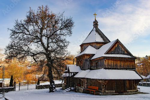 Old wooden church in Kamianets-Podilskyi, Ukraine at sunny winter day photo