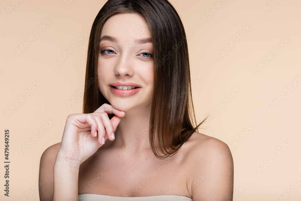 cheerful young woman with bare shoulders isolated on beige cheerful young woman with bare shoulders isolated on beige
