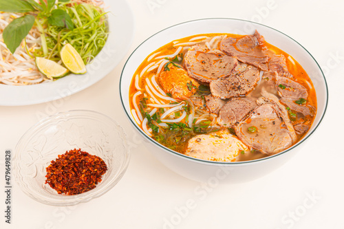 Fototapeta Naklejka Na Ścianę i Meble -  Bun Bo Hue, Vietnamese spicy beef rice noodle soup, Vietnamese food isolated on white background, closeup