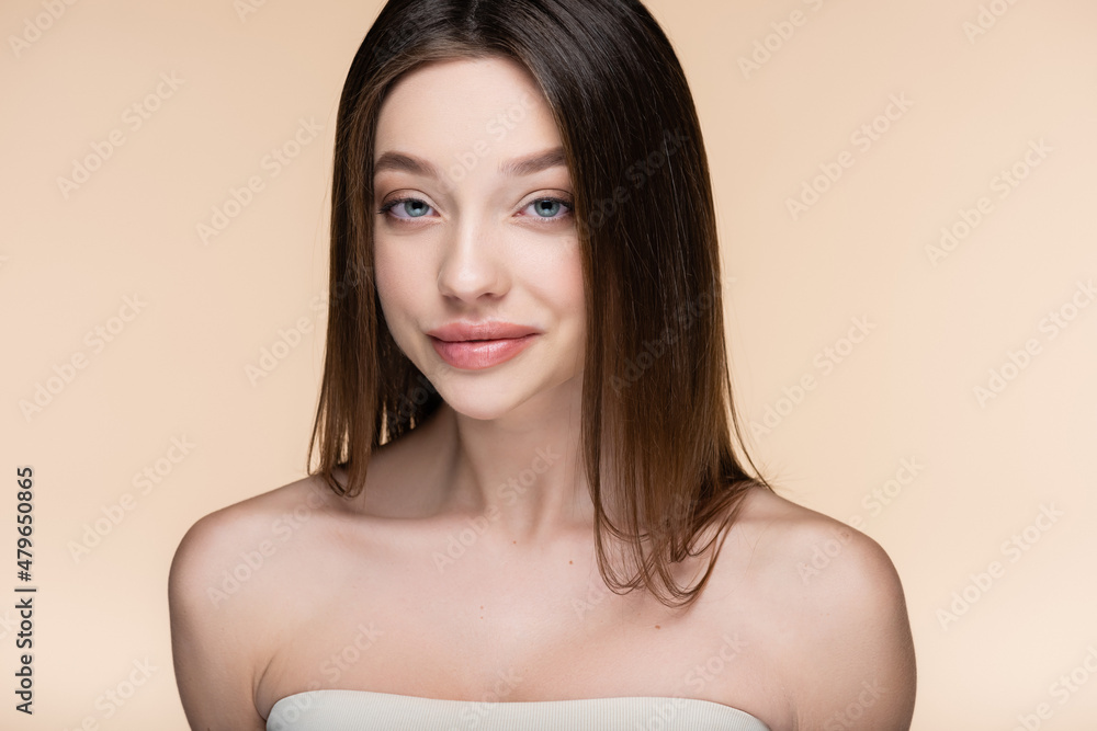 pretty young woman with bare shoulders smiling isolated on beige pretty young woman with bare shoulders smiling isolated on beige