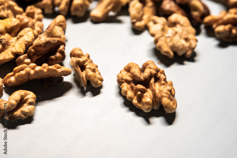 Close-up detail of already peeled walnut on a white table for a diet Close-up detail of already peeled walnut on a white table for a diet