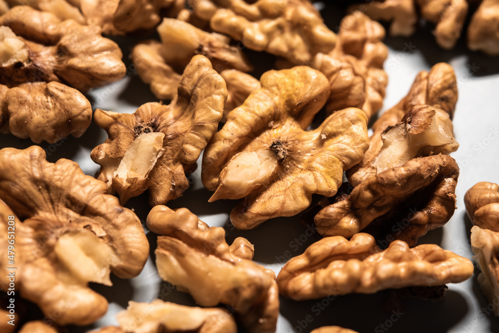 Close-up detail of already peeled walnut on a white table for a diet Close-up detail of already peeled walnut on a white table for a diet
