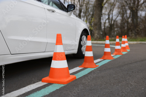 Modern car on test track with traffic cones, closeup. Driving school