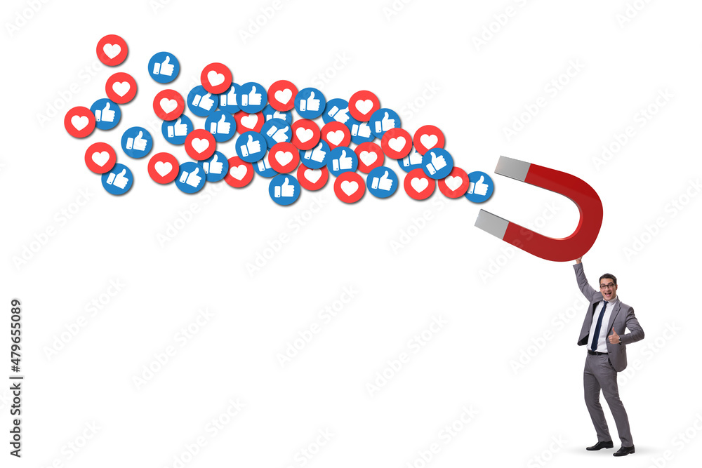 Businessman attracting likes with large magnet Businessman attracting likes with large magnet