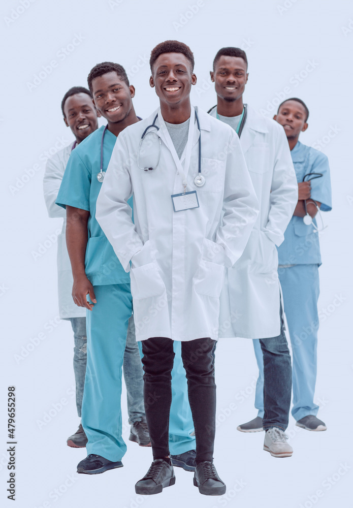 in full growth. smiling young doctors standing one by one in full growth. smiling young doctors standing one by one