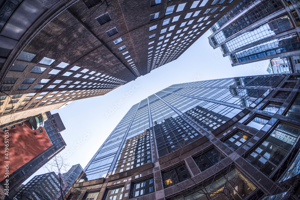 Office buildings appear to be falling towards each other. Photo taken with a fisheye lens.