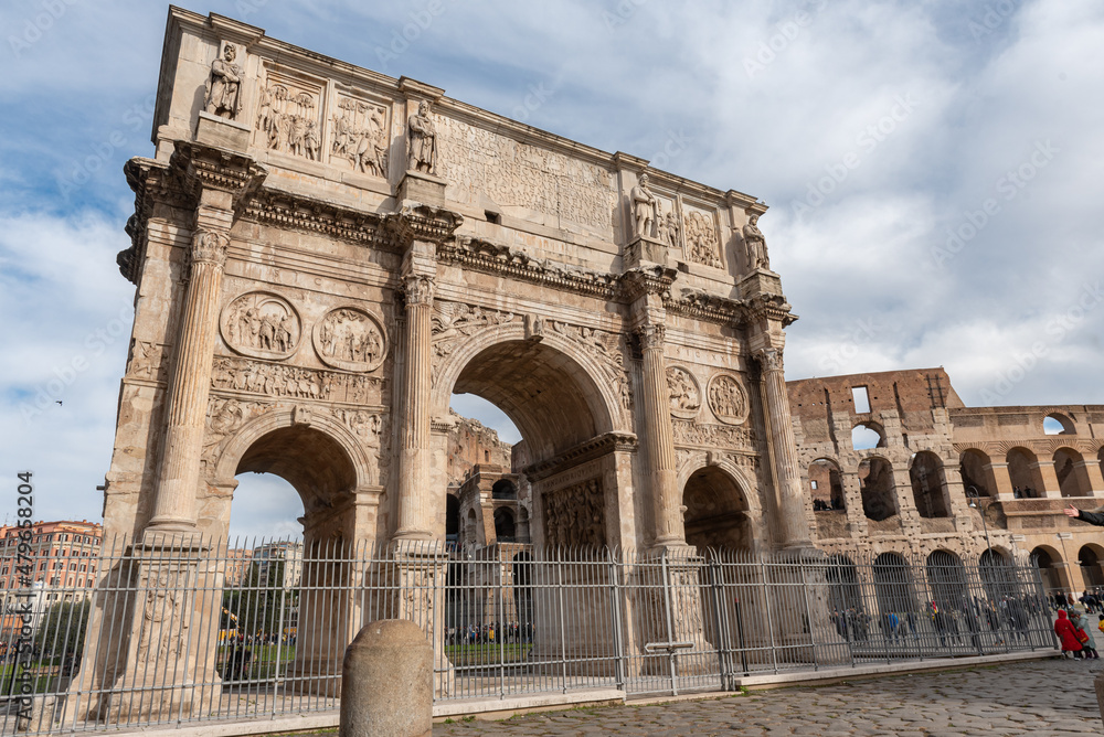 Arch of Constantine in the city of Rome with the Colosseum in the background