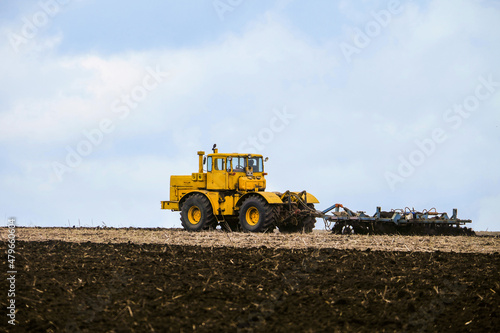 Wallpaper Mural Yellow powerful wheeled tractor pulls the disc harrow Torontodigital.ca