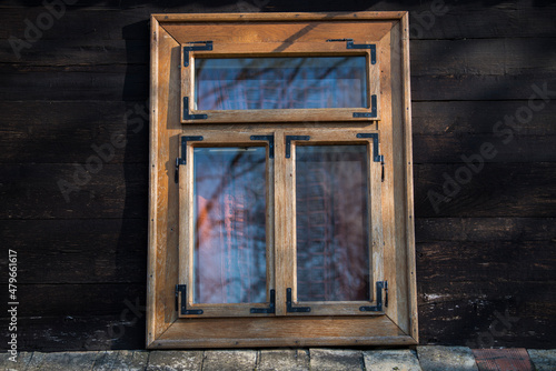 Sunja  Croatia  05 04 2021  Rustic style aged window in wooden village rural home wall.