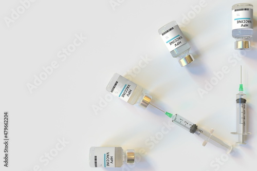 Clock face made with HPV vaccine vials and syringes. Vaccination time concept. Conceptual medical 3D rendering photo