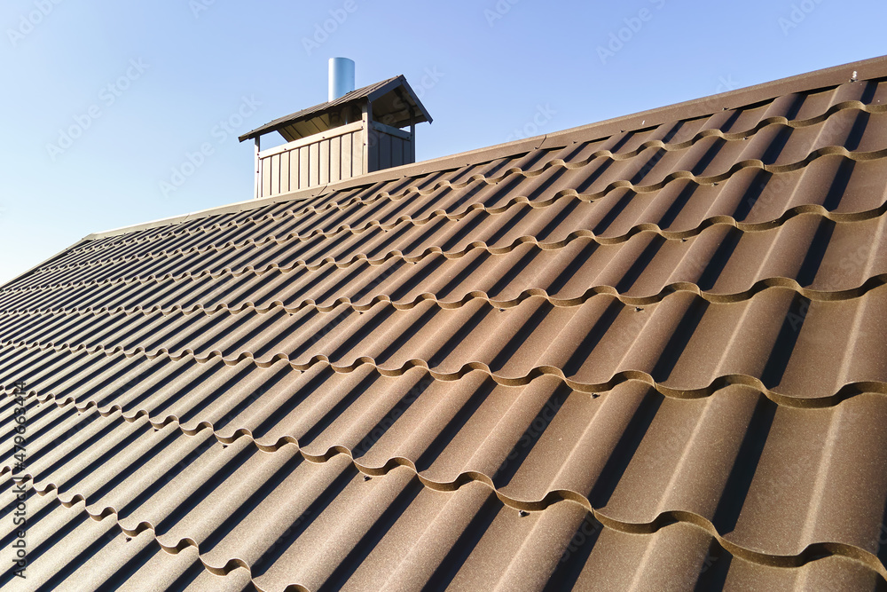 Closeup of house roof top covered with metallic shingles Closeup of house roof top covered with metallic shingles