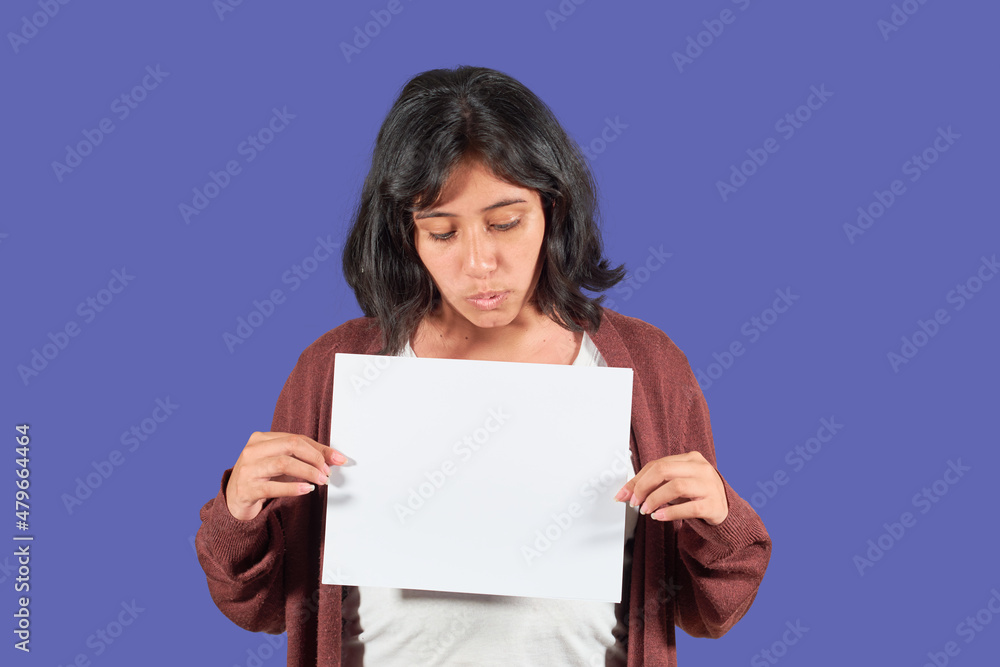Happy latin young woman showing blank advertisement. Isolated Happy latin young woman showing blank advertisement. Isolated