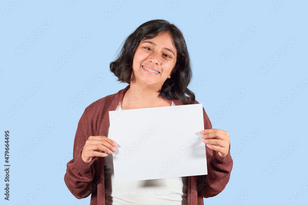 Happy latin young woman showing blank advertisement. Isolated Happy latin young woman showing blank advertisement. Isolated