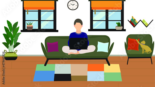 a boy is sitting on the sofa. the boy is working home office. the man is working on his laptop at home