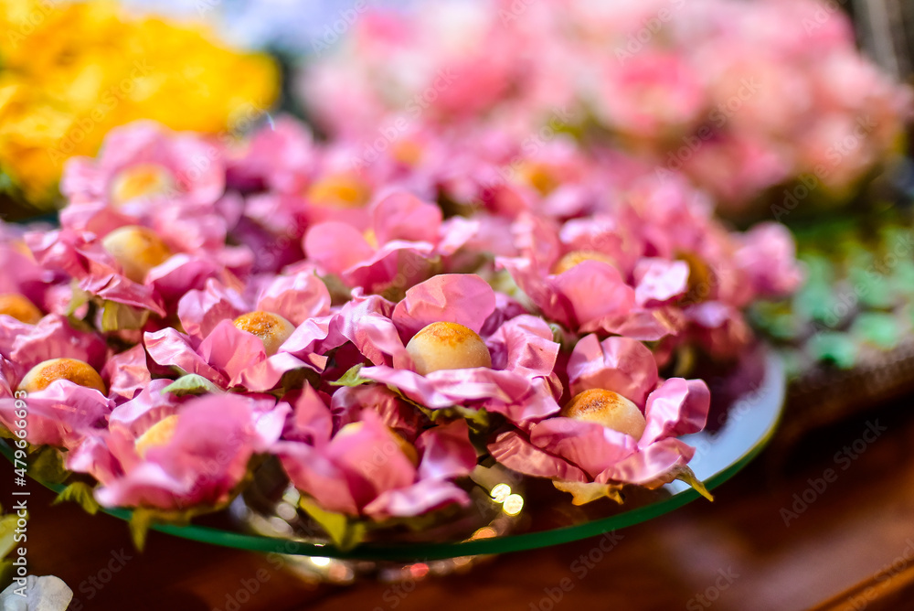 Obraz premium sweets in pink flower boxes, fine sweets table, condensed milk candy balls, candy balls, birthday party