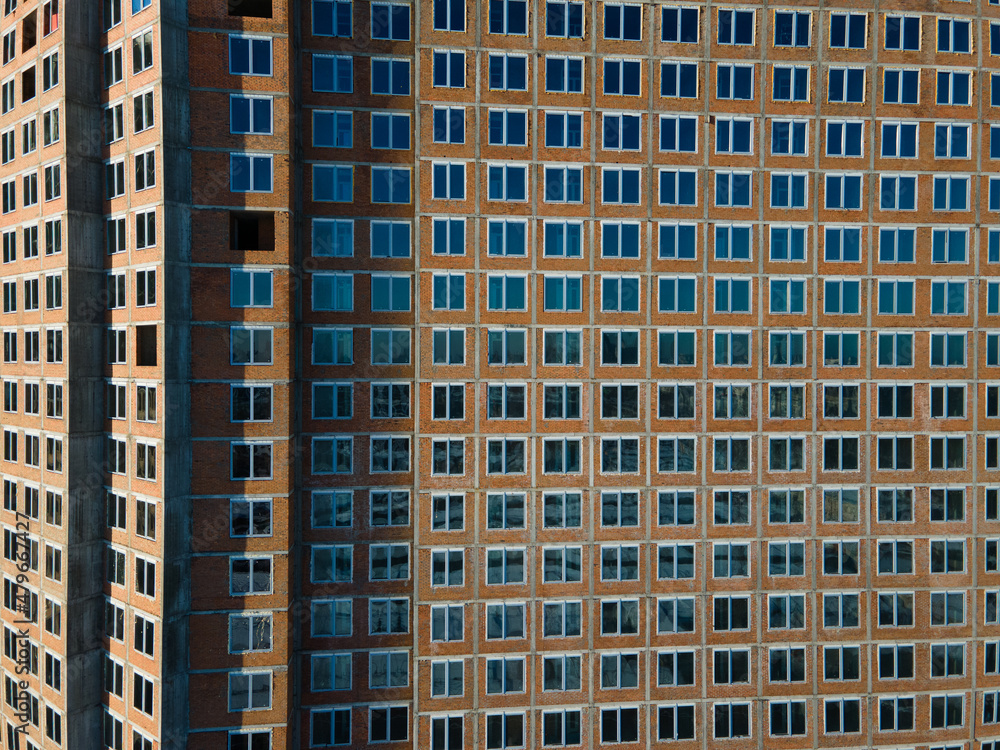 Aerial view from a drone to a pattern from the windows of an unfinished building