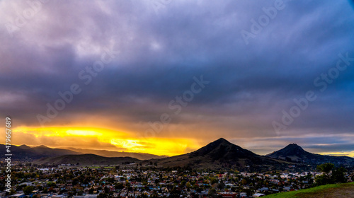 Sunrise, Sunset over the silhouetted Mountain Peaks, city, town