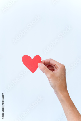 Vertical photo of a hand holding a heart