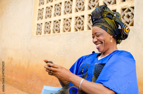 excited aged woman playing game on her smartphone photo