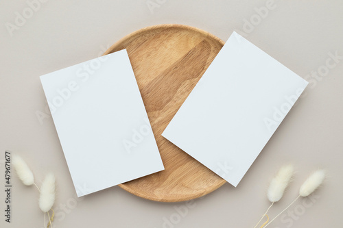 Blank paper cards, Greeting card Mockup with pampas grass on a wooden plate, beige background, Minimal beige workplace composition, flat lay, mockup photo
