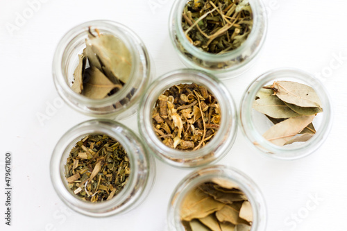 various dried herbs in glass jars. ethnoscience. view from above. herbal medicine.