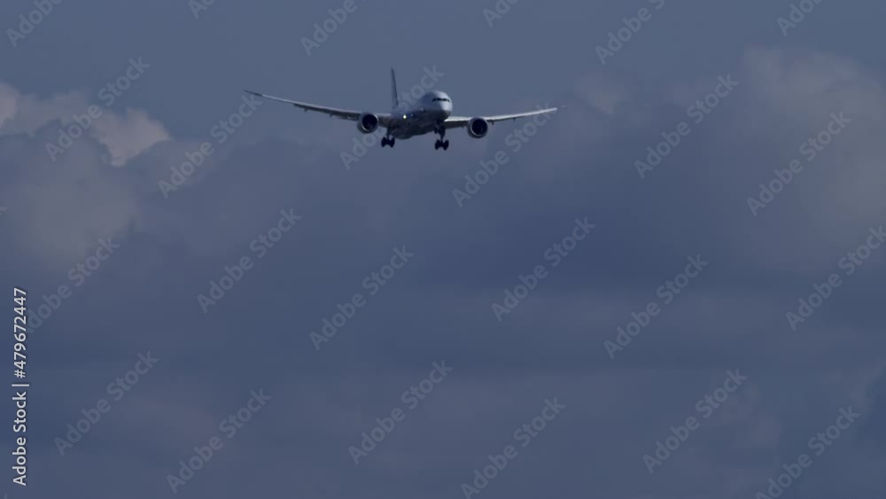 Passenger Airplane Flying Against Sky With Clouds On A Sunny Day. low angle, wide Passenger Airplane Flying Against Sky With Clouds On A Sunny Day. low angle, wide