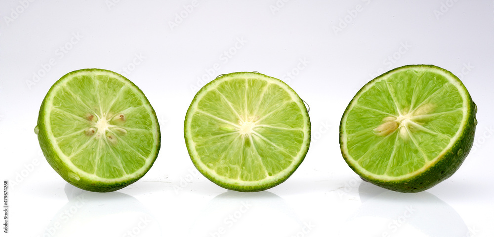 three fresh lime slices isolated on white background three fresh lime slices isolated on white background