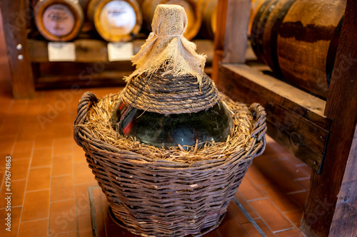 Traditional production and aging in wooden barrels of Italian Balsamic grapes vinegar dressing in Modena, Italy photo