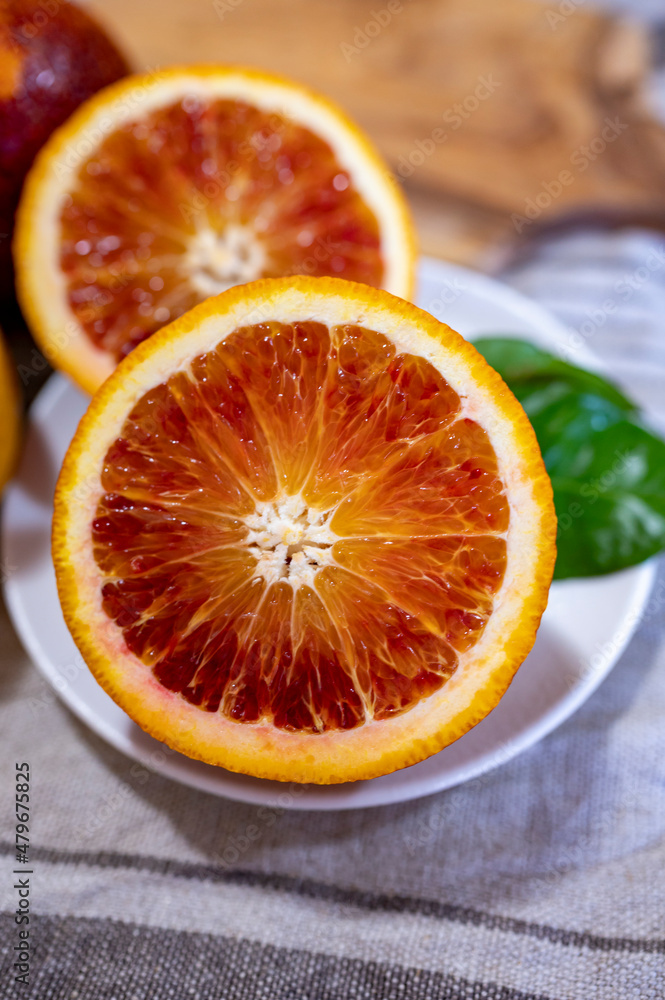 Sicilian sweet juicy yellow and red blood oranges with green leaves close up Sicilian sweet juicy yellow and red blood oranges with green leaves close up