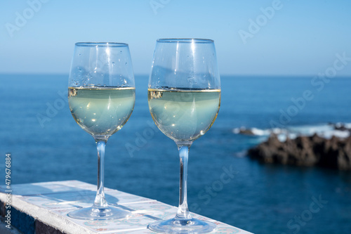 Drinking of white wine with view on blue Atlantic ocean on Tenerife, Canary islands, Spain