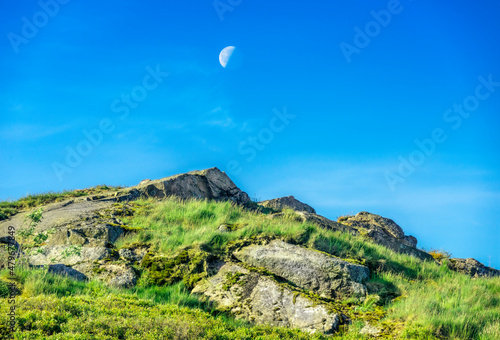 The Moon rising at dawn,over the summit of Worcestershire Beacon, Malvern Hills,Worcestershire,England.