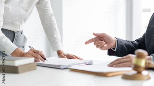 Konstfotografi law concept The barrister helper standing, holding a pen in his hand, and readin