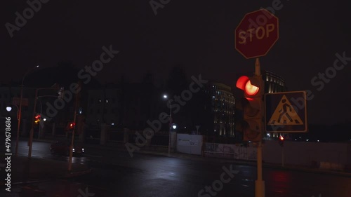 Wallpaper Mural Stop sign and pedestrian crossing signage hanging on street pole at night road with car is starting drive with green signal traffic light Torontodigital.ca