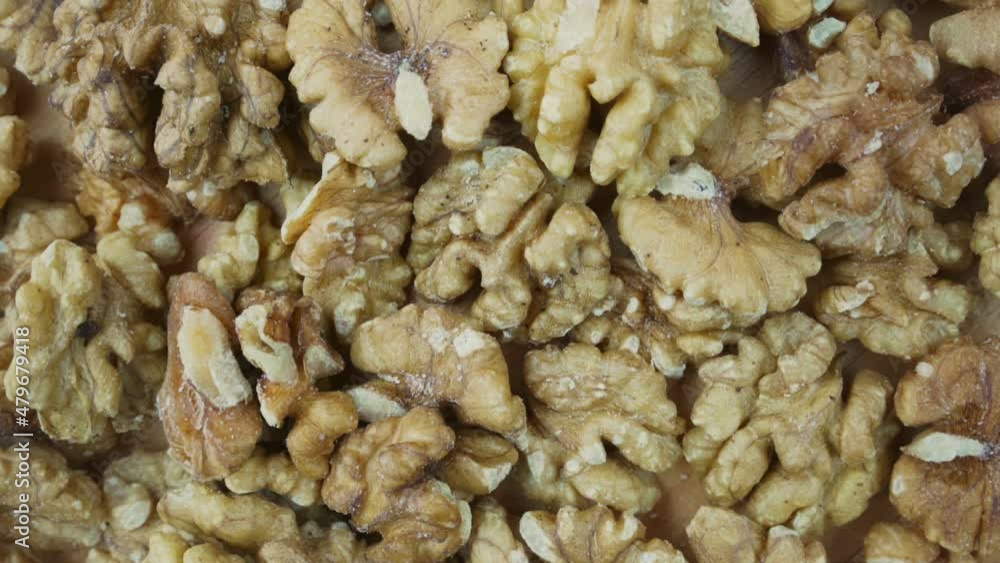 Pile of peeled half of walnut background rotate top close view. Healthy nutrition and diet conception. Pile of peeled half of walnut background rotate top close view. Healthy nutrition and diet conception.