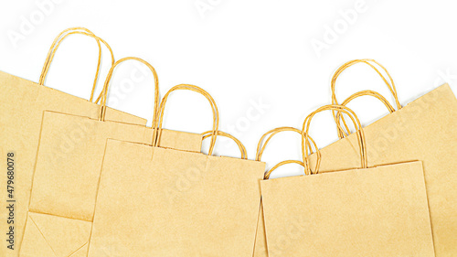 Lot of paper eco-friendly kraft bags on white background top view