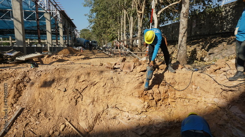 Workers are drilling at a construction site.
