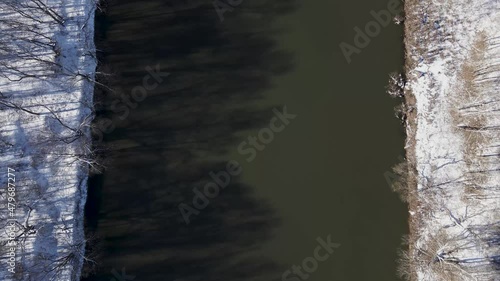 aerial top down view snowy flying down river