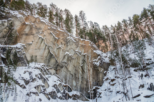 Sheer cliffs and rocks around the Talc quarry in winter in Russia in the town of Sysert, near Yekaterinburg. photo