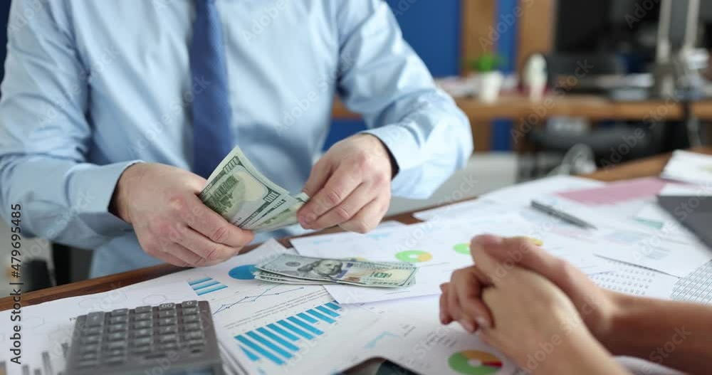 Businessman counting dollar bill in front of woman in office 4k movie slow motion Businessman counting dollar bill in front of woman in office 4k movie slow motion