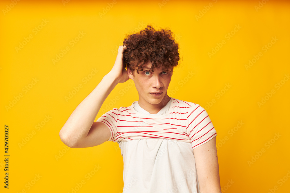 portrait of a young curly man striped t shirt posing summer clothing isolated background unaltered portrait of a young curly man striped t shirt posing summer clothing isolated background unaltered