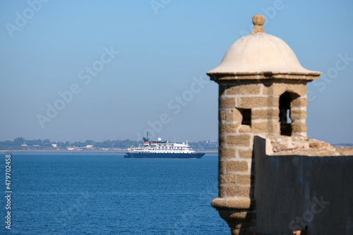 Luxury expedition cruiseship cruise ship liner yacht Island Sky Hebridean Sky in port of Malaga, Spain Andalusia with city skyline, marina and blue sky on sunny day during Mediterranean cruising photo