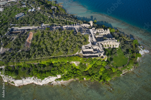 Olive grove and archaeological museum. Aerial view of the Grotte di Catullo ruins of a large Roman villa on the peninsula. Grottoes ruins on the Sirmione peninsula. Lake Garda, Italy. © Berg