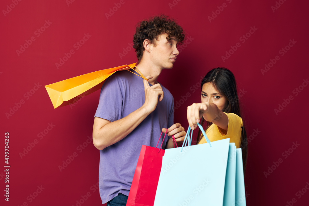 teenagers colorful bags shopping fun red background unaltered