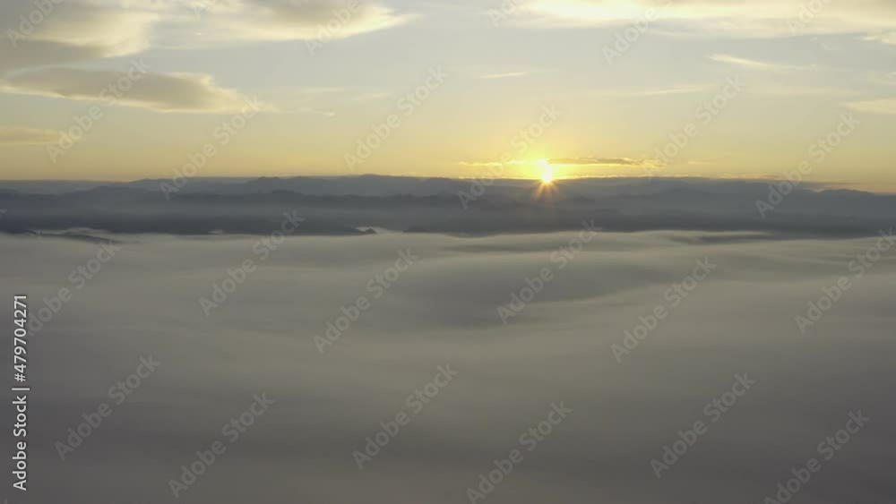 Aerial view of the rising sun from the mountains in the morning. Beautiful clouds. Aerial view of the rising sun from the mountains in the morning. Beautiful clouds.