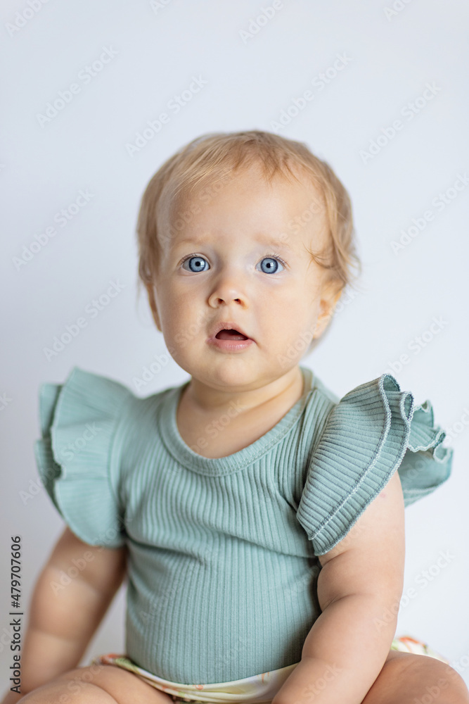 little caucasian baby girl ten months old at home or nursery. Child wearing fashionable clothing little caucasian baby girl ten months old at home or nursery. Child wearing fashionable clothing